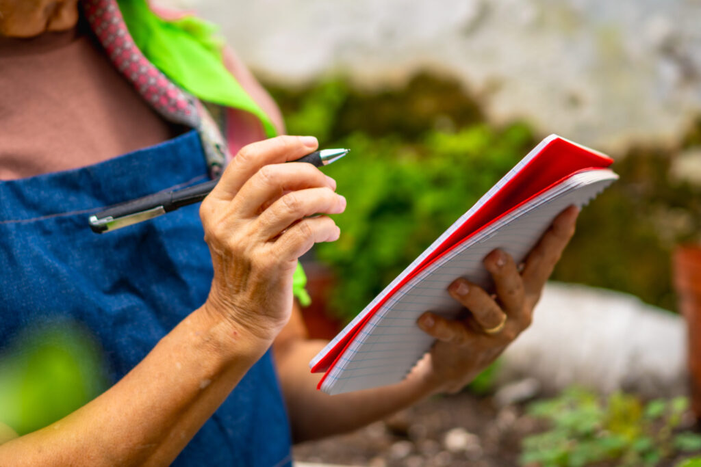 gardener writing in a notebook
